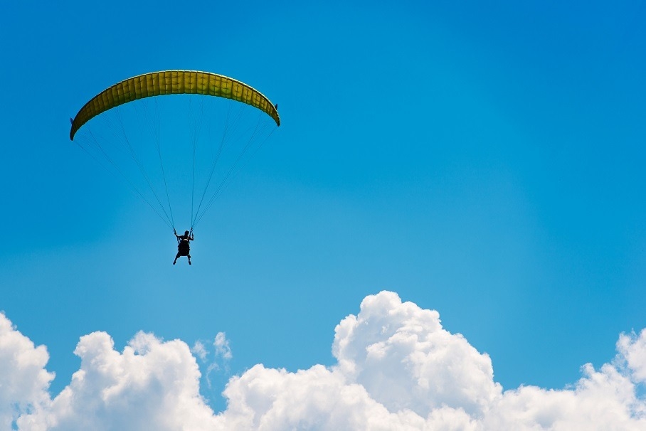 Parachute Over Blue Sky. Parachute Fly. Extreme Sports Concept Photo.