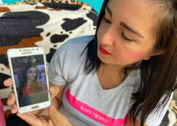 Ainda triste e consternada, Morgana mostra uma das fotos da irmã que tem no celular 
(Fotos: Melissa Costa)